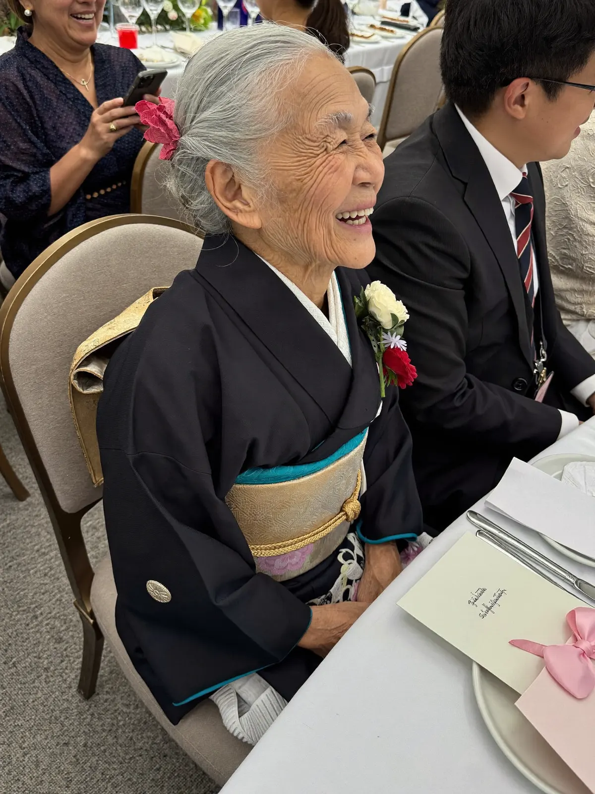 披露宴のテーブルで笑う着物姿の祖母
